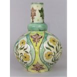 A Della Robbia pottery vase with bulbous body and drawn neck and painted stylised floral decoration,