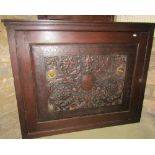 An unusual 19th century corner cupboard, the single panelled door enclosed by an embossed leather