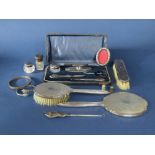 A box of various silver dressing and bijouterie items to include a cased silver topped manicure set,