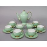 A collection of Paragon china coffee wares with pale green speckled glaze finish, comprising