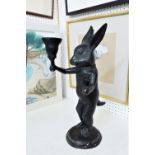Interesting verdigris cast metal study of a standing rabbit or hare holding a torch, upon a