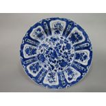An oriental Kraak plate, with blue and white painted flower vase detail to the centre, within