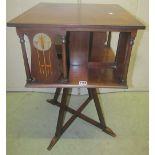 An Art Nouveau mahogany revolving bookcase of square cut form, the four divisions each with