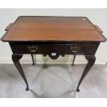 An Edwardian mahogany tray top occasional table over a single frieze drawer, incorporating two