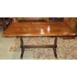 A stained elm refectory table (possibly Ercol or Priory) of rectangular form, with rounded