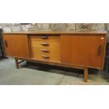 A retro teak veneered long and low sideboard, enclosed by two sliding doors with sculptural handles,