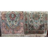 A pair of Persian silk prayer mats, one with a green colourway, the other with red, both on an ivory