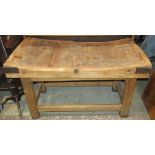 A substantial well used butchers block of rectangular form, raised on a pine stand with square cut