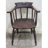 A stained elm and beechwood bow back chair, with vertical splats and saddle shaped seat, raised on