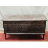 An early oak boarded coffer, the front elevation with geometric carved decoration, monogrammed and