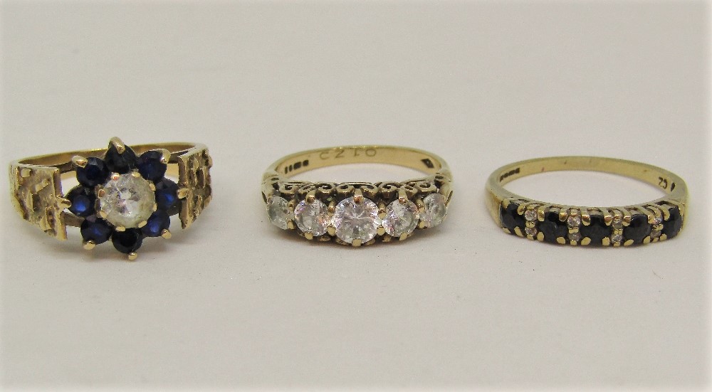 Three 9ct dress rings set with cubic zirconia and blue spinels, sizes M - O, 8.8g total (3)