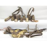 A collection of 19th century brassware including five martingales, three tin cow bells, further