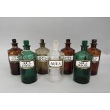 A collection of seven antique apothecary bottles, three brown glass, one smoked glass, two green and