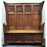 A good quality carved and panelled oak settle, with box seat, incorporating high quality carvings,