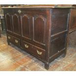 A 18th century oak mule chest, the rising lid over four shaped and field panels, over two frieze