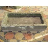 A shallow weathered natural stone trough/sink of rectangular form with single drainage hole, 81 cm