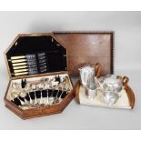 An oak canteen containing a quantity of plated flatware, together with a four piece Picquot ware tea