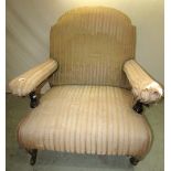 A wide body Edwardian drawing room/library chair with arched back, open arms and low seat with