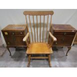 A pair of bedside cupboards in the Queen Anne style with fall fronts and frieze drawers on shaped