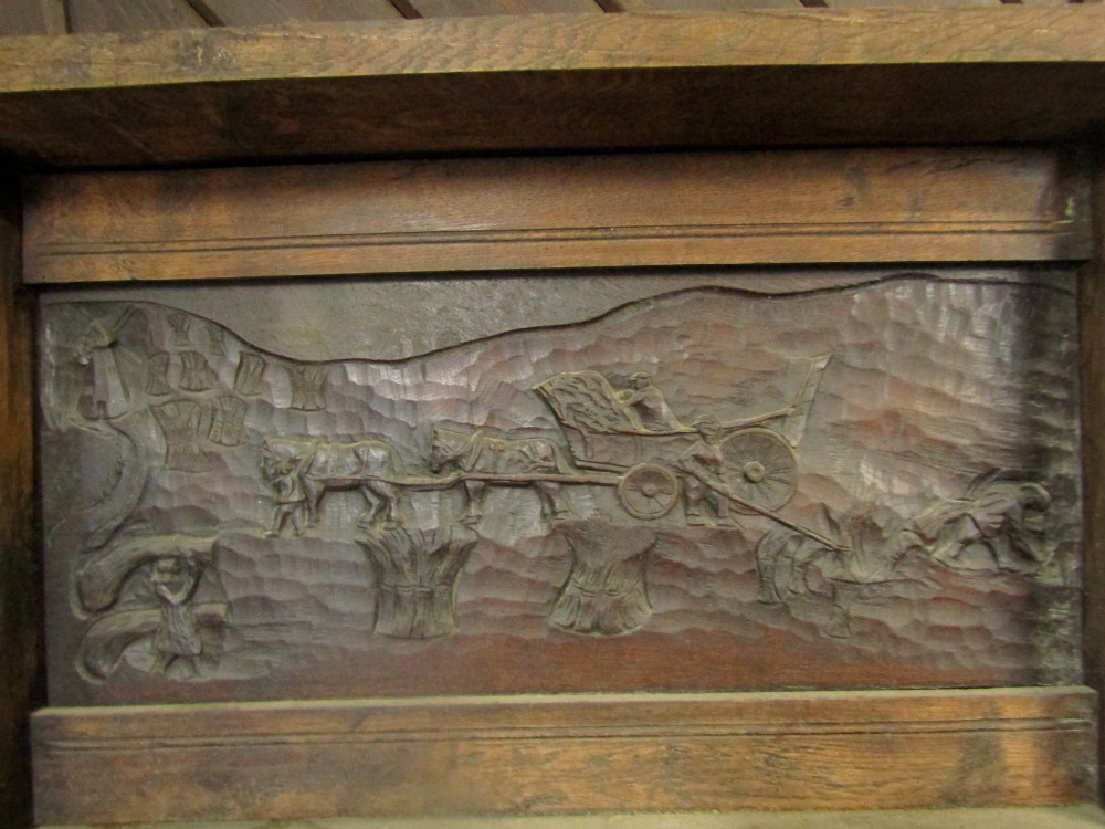 A substantial oak fire surround with pegged frame, the raised back with carved panel of a harvesting - Image 2 of 2