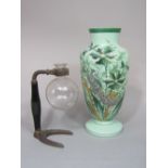 A 19th century opaline glass baluster vase decorated in relief with a peacock amidst foliage with
