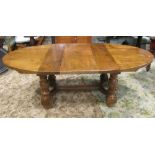 A substantial medium oak D end draw leaf extending dining table with single additional leaf,