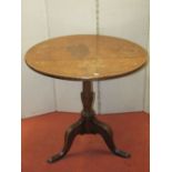 A Georgian oak snaptop table, 73cm diameter top raised on a vase shaped pillar and tripod base,