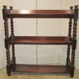 A 1920s oak three tier book stand raised on barley twist supports together with small walnut