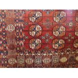 A Bokhara rug with typical coloured medallions upon a red ground, 260 x 180 cm