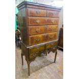 A Georgian chest of three long and two short drawers, raised on a stand incorporating four further