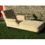 A Victorian upholstered day bed with deep button back, scrolled arms and raised on square taper legs