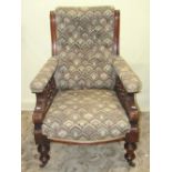 A Victorian drawing room chair with later stylised upholstered seat, button back and arms, raised on