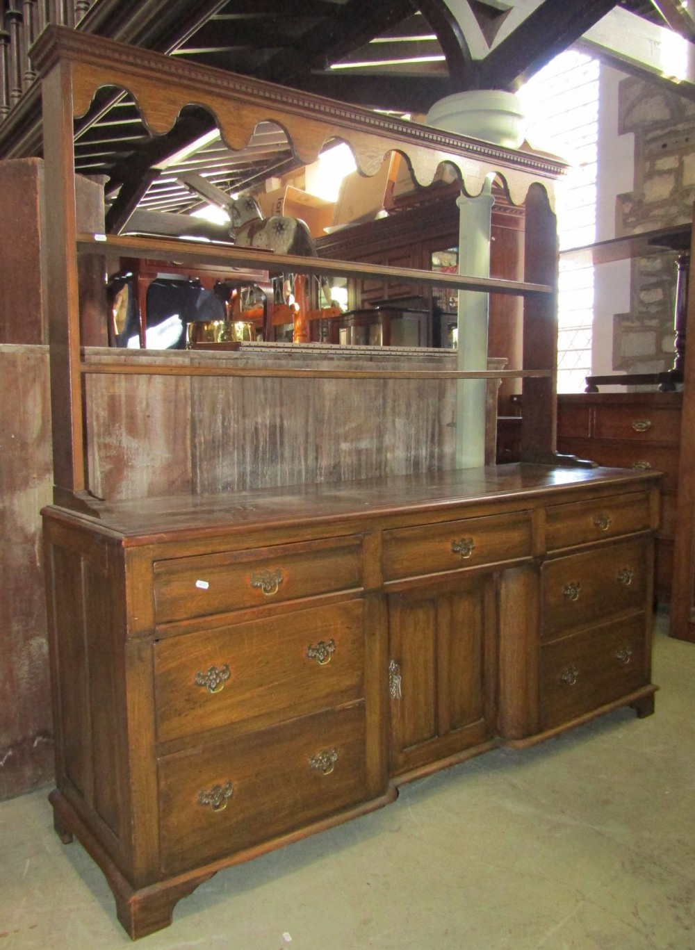 A late 19th century oak dresser and plate rack, the lower section enclosed by an arrangement of