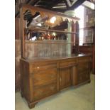 A late 19th century oak dresser and plate rack, the lower section enclosed by an arrangement of