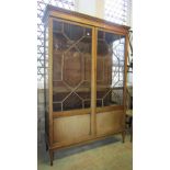 An inlaid Edwardian mahogany freestanding display cabinet, enclosed by a pair of full length