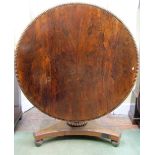 A Regency rosewood breakfast table, the circular top with beaded borders, raised on a vase shaped