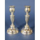 Pair of 1920s silver baluster candlesticks upon stepped circular bases, maker marks rubbed, London