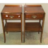 A pair of walnut veneered two tier bedside lamp tables, each fitted with a frieze drawer and