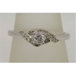 9ct white gold diamond crossover style ring, centre stone 0.20cts approx, size R, 2.4g