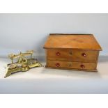 A plain wood writing slope over two frieze drawers together with a set of cast brass postal scales