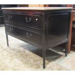 An oak commode of two long drawers, raised on turned and fluted supports, with painted finish