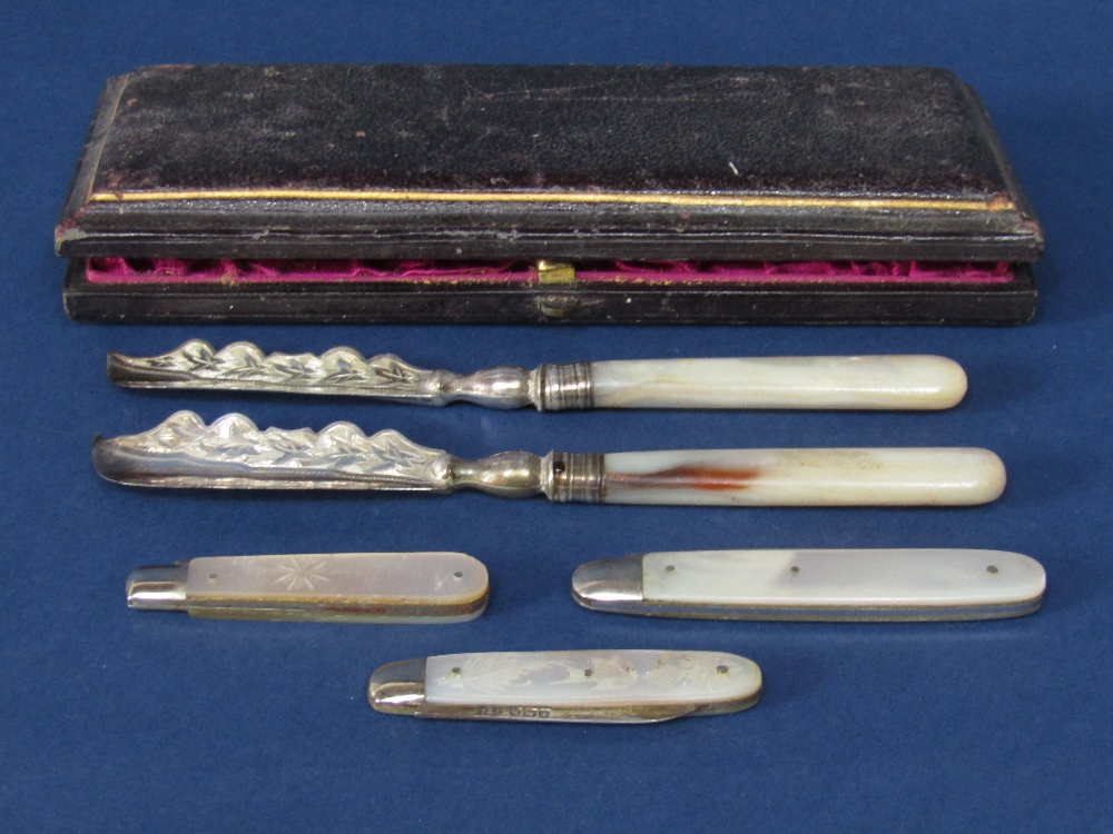 Cased pair of Victorian pearl handled silver fruit knives, the shaped blades with engraved