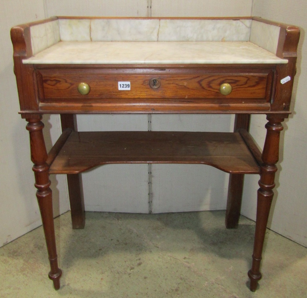 A 19th century continental pitch pine washstand on two tiers, fitted with a frieze drawer, marble