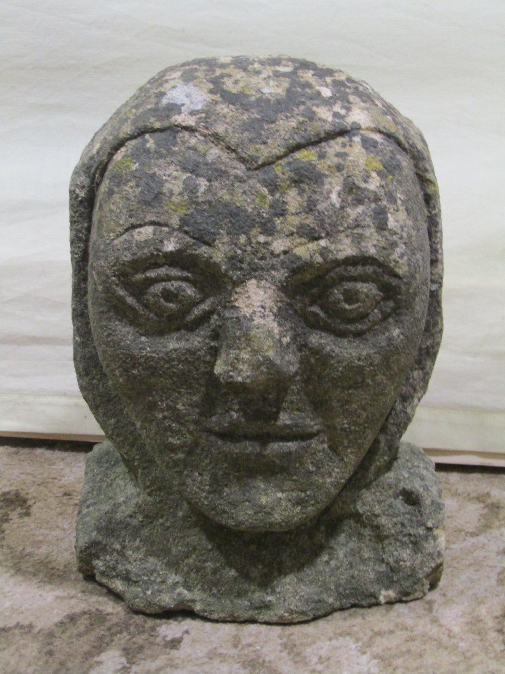 Antique stone corbel in the form of a face, 23cm high