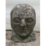 Antique stone corbel in the form of a face, 23cm high
