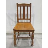A set of nine (8+1) 1920s medium coloured oak dining chairs, the vertical rail backs with applied