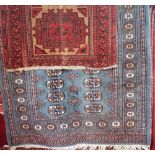 Bokhara rug with typical geometric medallions upon a blue ground, 160 x 90 cm; together with an