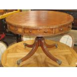 A Georgian mahogany drum table, the circular top with inset leather detail over four real and four