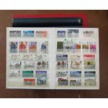 A stamp album containing a collection of British stamps, pre and post decimalisation and including