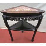 A 19th century Chinese hardwood corner table raised on three carved supports with pierced frieze and